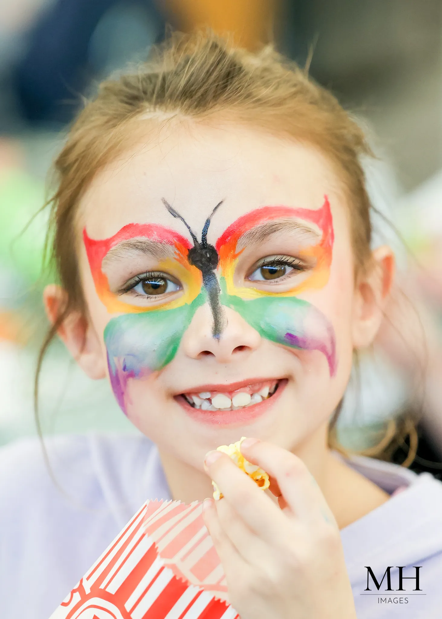 Child with colorful butterfly face paint