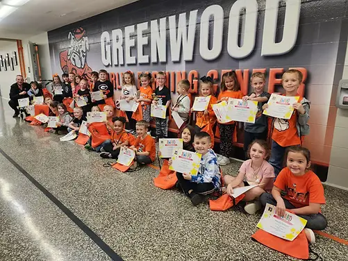 Students at Greenwood Learning Center with their books and certificates